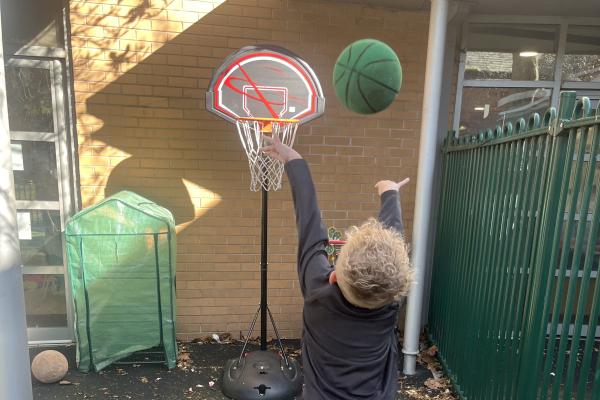 older boy playing basketball